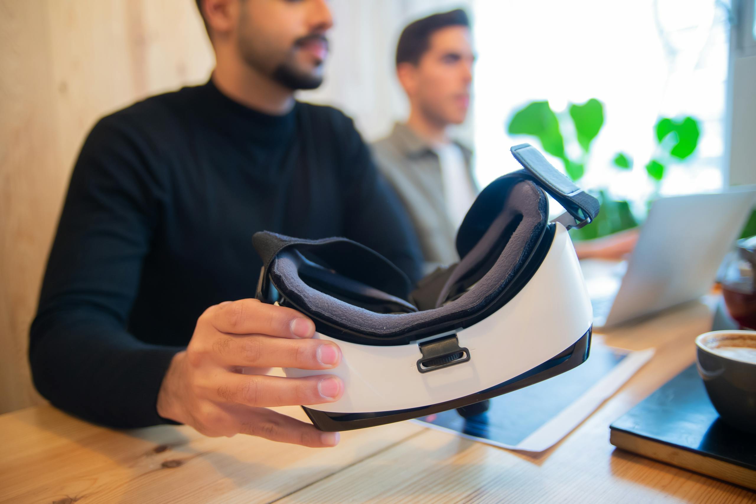 Professional team exploring virtual reality headset in an office setting for innovative solutions.